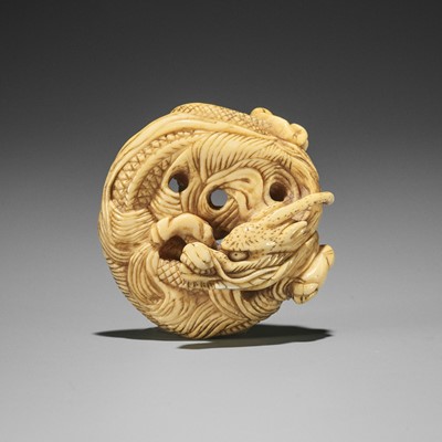 Lot 14 - AN IVORY NETSUKE OF A COILED ONE-HORNED DRAGON