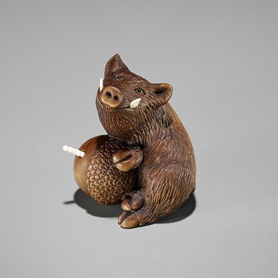 DERKACHENKO: A WOOD NETSUKE OF A BOAR WITH ACORN