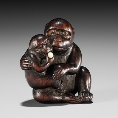 Lot 180 - HIDECHIKA: A CHARMING INLAID WOOD NETSUKE OF A MONKEY FEEDING YOUNG