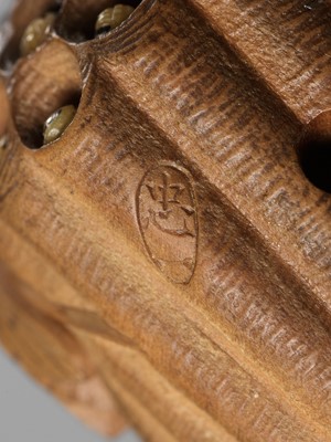 Lot 105 - TADAKAZU: A FINE WOOD NETSUKE OF A WASP NEST WITH MOVABLE LARVAE