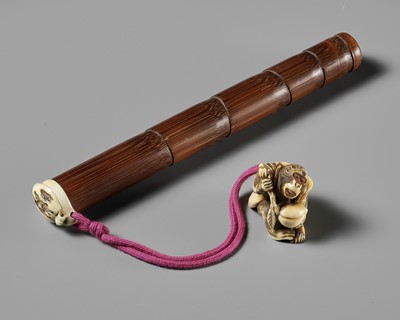 A FINE BAMBOO AND ANTLER YATATE, WITH AN ANTLER NETSUKE OF A MONKEY HOLDING A PEACH