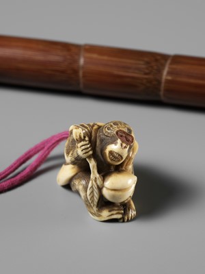 A FINE BAMBOO AND ANTLER YATATE, WITH AN ANTLER NETSUKE OF A MONKEY HOLDING A PEACH