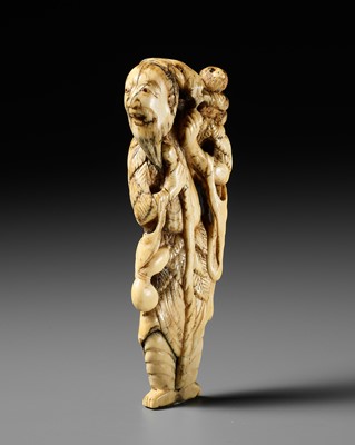 AN EARLY AND LARGE MARINE IVORY NETSUKE OF SENNIN WITH MONKEY