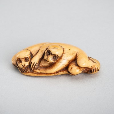 Lot 1295 - AN EARLY IVORY NETSUKE OF TWO MONKEYS LYING ON A MAT