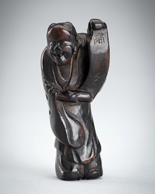 A SIGNED WOOD NETSUKE OF A MAN WITH SCROLL, EDO PERIOD