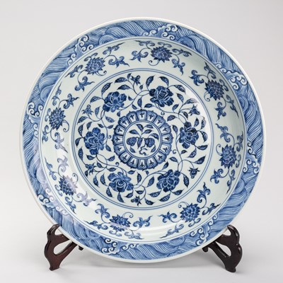 Lot 2003 - A LARGE MING STYLE BLUE AND WHITE ‘AUSPICIOUS FLOWERS’ PORCELAIN CHARGER