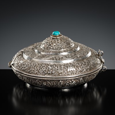 Lot 290 - A TURQUOISE-INLAID SILVER REPOUSSÉ BETEL NUT BOX AND COVER, BHUTAN, EARLY 19TH CENTURY