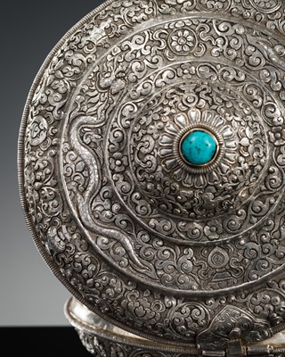 Lot 290 - A TURQUOISE-INLAID SILVER REPOUSSÉ BETEL NUT BOX AND COVER, BHUTAN, EARLY 19TH CENTURY