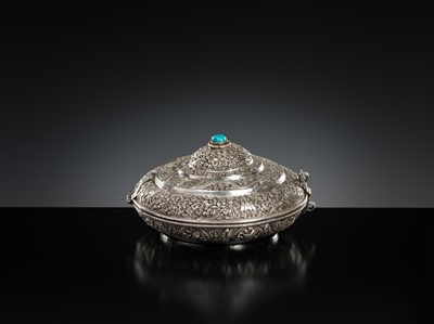 Lot 290 - A TURQUOISE-INLAID SILVER REPOUSSÉ BETEL NUT BOX AND COVER, BHUTAN, EARLY 19TH CENTURY