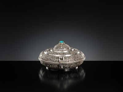 Lot 290 - A TURQUOISE-INLAID SILVER REPOUSSÉ BETEL NUT BOX AND COVER, BHUTAN, EARLY 19TH CENTURY