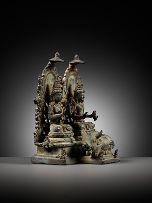 Lot 202 - A RARE BRONZE GROUP DEPICTING SHIVA AND PARVATI WITH NANDI, CENTRAL JAVA, CIRCA 900-950 AD