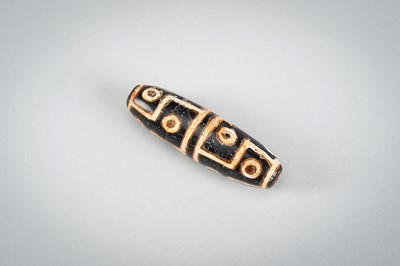 Lot 1517 - A LOT WITH TWO TIBETAN AGATE DZI BEADS, 18TH CENTURY OR EARLIER