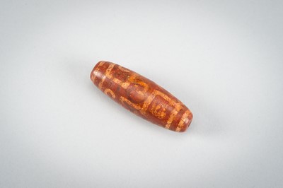 Lot 1517 - A LOT WITH TWO TIBETAN AGATE DZI BEADS, 18TH CENTURY OR EARLIER