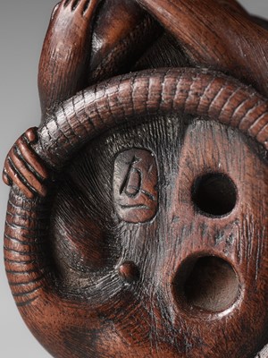 Lot 112 - TOMOKAZU: A FINE WOOD NETSUKE OF A RAT EATING A CHESTNUT