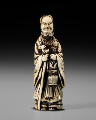 AN ANTLER NETSUKE OF A CHINESE IMMORTAL