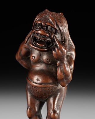Lot 115 - A SUPERB WOOD NETSUKE OF A MISCHIEVOUS ONI, ATTRIBUTED TO IKKYU