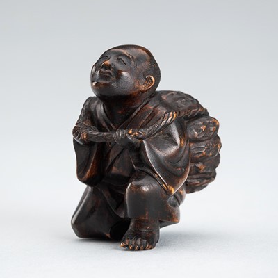 A WOOD NETSUKE OF A PEASANT WITH PUMPKIN, MEIJI