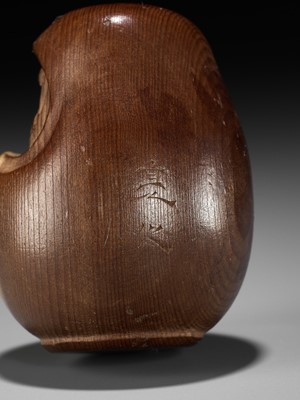 Lot 278 - SUKEYUKI: A RARE HIDA SCHOOL ITTOBORI YEW WOOD NETSUKE OF A DARUMA DOLL