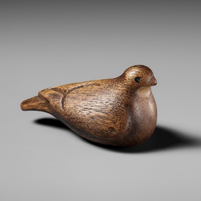 A YEW WOOD NETSUKE OF A DOVE