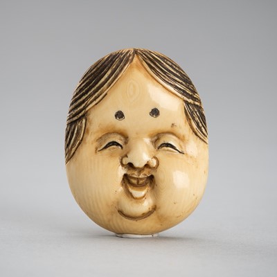 Lot 485 - A CHARMING IVORY MASK NETSUKE OF OKAME