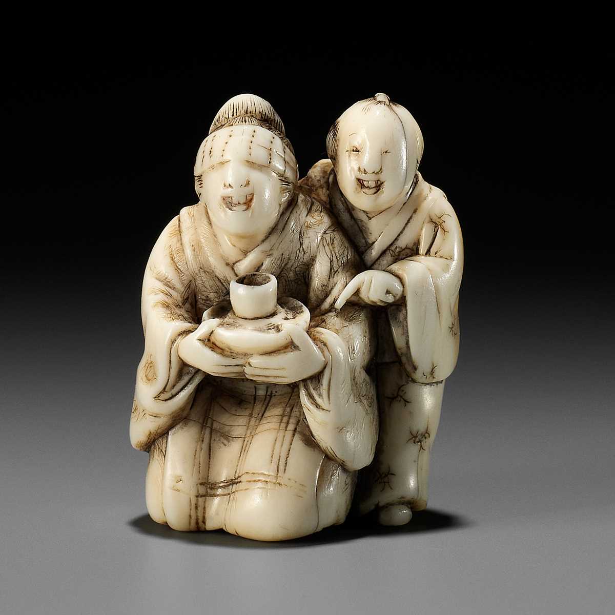 Lot 174 - A RARE IVORY NETSUKE OF A BLINDFOLDED GEISHA