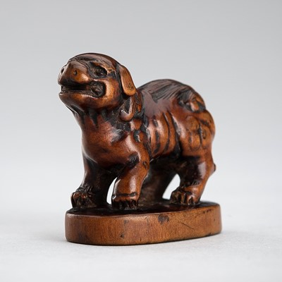 TOSAI: A GOOD WOOD NETSUKE OF A SHISHI