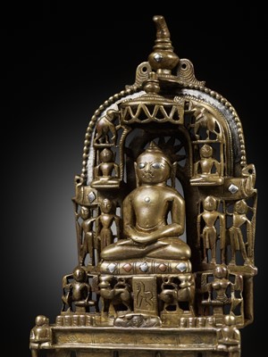 Lot 254 - A JAIN SILVER AND COPPER-INLAID BRASS SHRINE TO SAMBHAVANATHA, DATED 1464