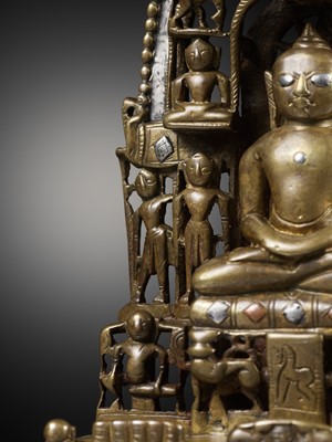 Lot 254 - A JAIN SILVER AND COPPER-INLAID BRASS SHRINE TO SAMBHAVANATHA, DATED 1464