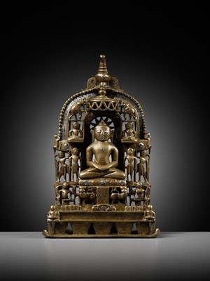 Lot 254 - A JAIN SILVER AND COPPER-INLAID BRASS SHRINE TO SAMBHAVANATHA, DATED 1464
