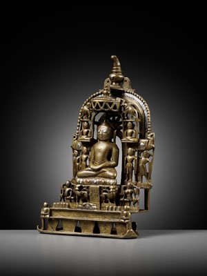 Lot 254 - A JAIN SILVER AND COPPER-INLAID BRASS SHRINE TO SAMBHAVANATHA, DATED 1464
