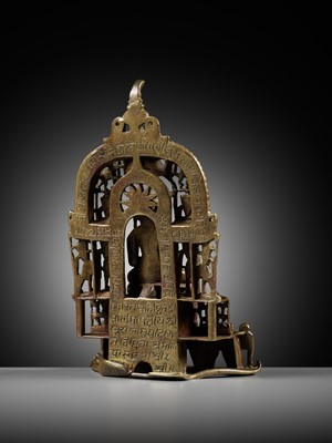 Lot 254 - A JAIN SILVER AND COPPER-INLAID BRASS SHRINE TO SAMBHAVANATHA, DATED 1464