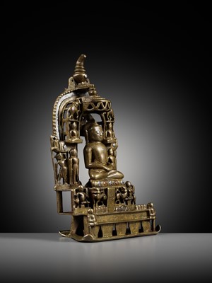 Lot 254 - A JAIN SILVER AND COPPER-INLAID BRASS SHRINE TO SAMBHAVANATHA, DATED 1464