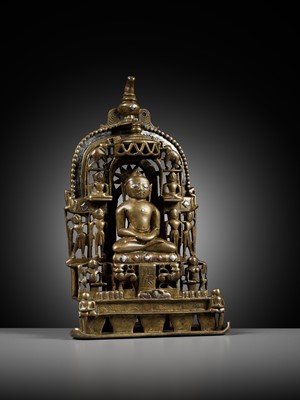 Lot 254 - A JAIN SILVER AND COPPER-INLAID BRASS SHRINE TO SAMBHAVANATHA, DATED 1464