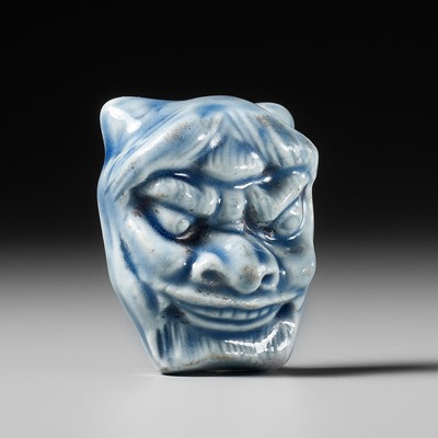 Lot 472 - A HIRADO PORCELAIN MASK NETSUKE OF HANNYA