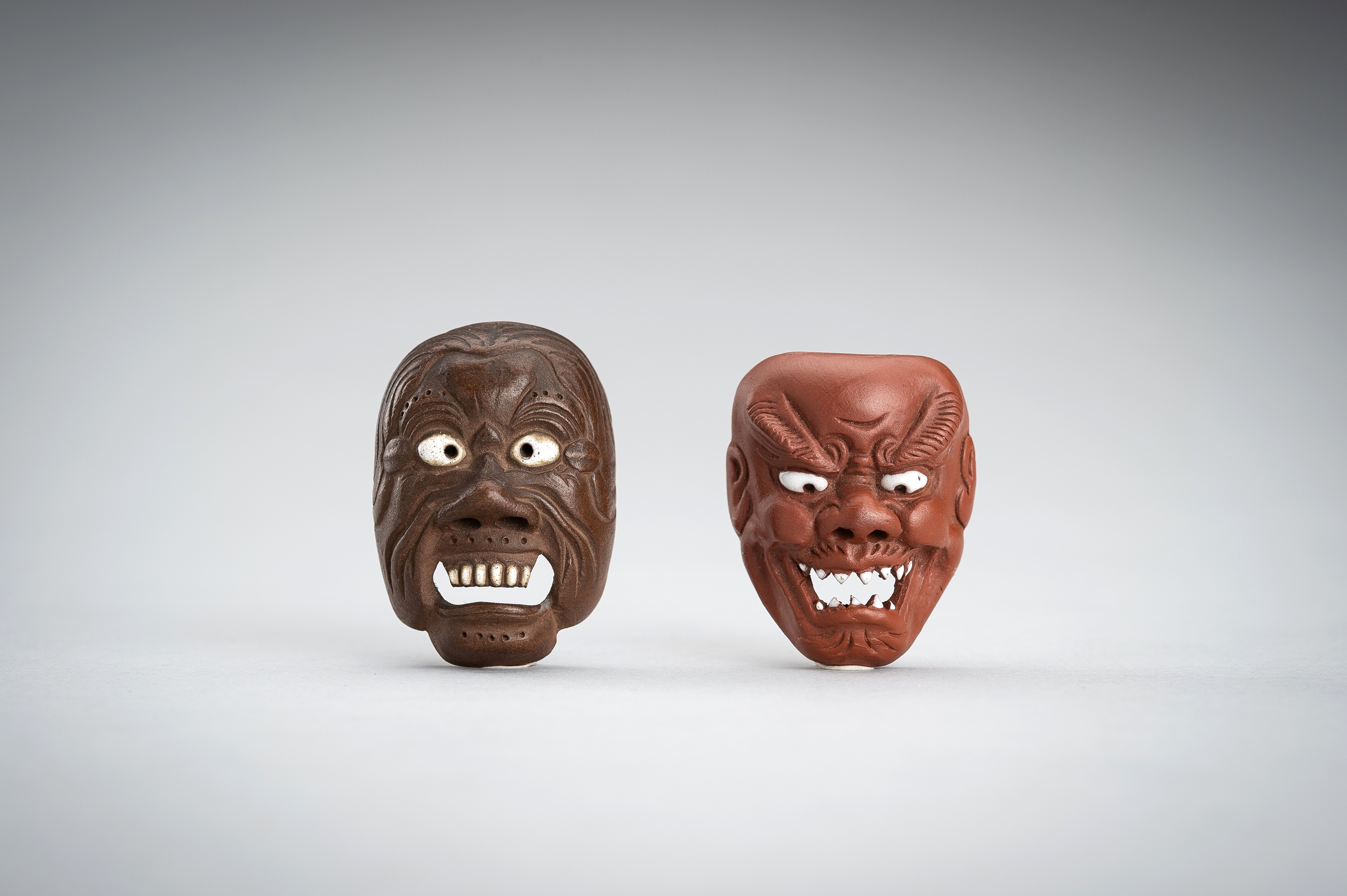 Lot 490 - A LOT WITH EIGHT ONKO POTTERY AND WOOD MASK