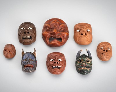 Lot 490 - A LOT WITH EIGHT ONKO POTTERY AND WOOD MASK NETSUKE