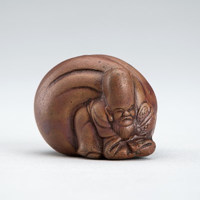 A BIZEN-YAKI NETSUKE OF FUKUROKUJU CARRYING A TREASURE BAG