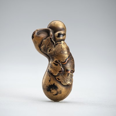 A LACQUERED WOOD NETSUKE OF A LEAFY GOURD