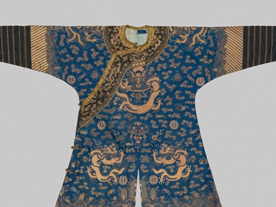 Lot 393 - A SILK GOLD AND BLUE-GROUND ‘NINE DRAGONS’ ROBE, JIFU, QING DYNASTY