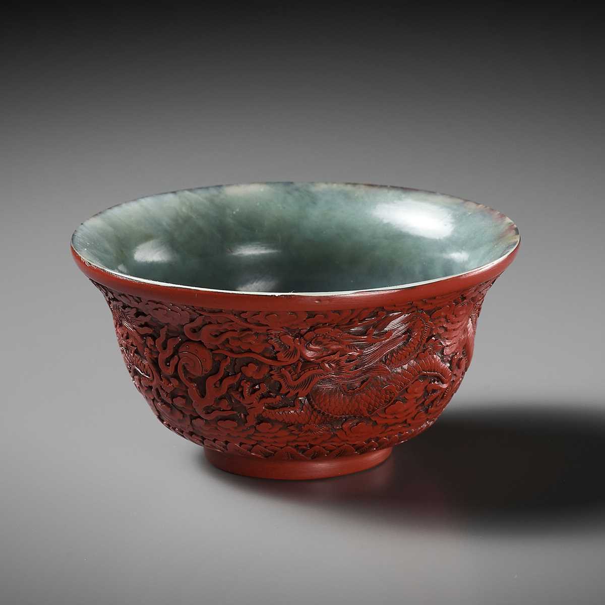 Lot 88 - AN EXCEEDINGLY RARE CINNABAR LACQUER-EMBELLISHED JADE BOWL, QIANLONG PERIOD