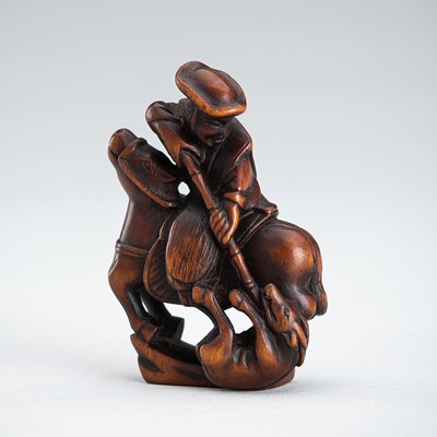 Lot 557 - A WOOD NETSUKE OF A HUNTER AND DEER, EDO PERIOD