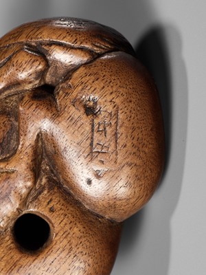 Lot 107 - YASUTADA: A RARE WOOD NETSUKE OF A RECUMBENT HORSE