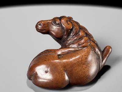 Lot 107 - YASUTADA: A RARE WOOD NETSUKE OF A RECUMBENT HORSE