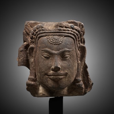 A RED STANDSTONE HEAD OF AN APSARA, KHMER EMPIRE, 10TH-12TH CENTURY
