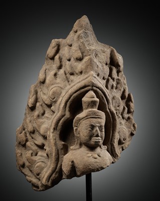 A SANDSTONE ANTEFIX OF A MALE DEITY, ANGKOR PERIOD