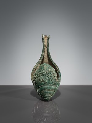 Lot 357 - A BRONZE RITUAL CONCH SHELL WITH A DANCING FIGURE OF HEVAJRA, ANGKOR PERIOD, BAYON STYLE