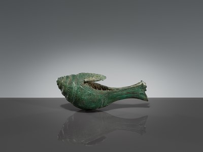 Lot 357 - A BRONZE RITUAL CONCH SHELL WITH A DANCING FIGURE OF HEVAJRA, ANGKOR PERIOD, BAYON STYLE