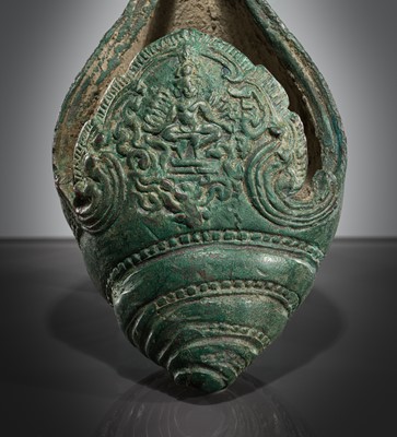 Lot 357 - A BRONZE RITUAL CONCH SHELL WITH A DANCING FIGURE OF HEVAJRA, ANGKOR PERIOD, BAYON STYLE