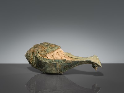 Lot 356 - A BRONZE RITUAL CONCH SHELL WITH A FIGURE OF HEVAJRA WITH YOGINIS, ANGKOR PERIOD, BAYON STYLE