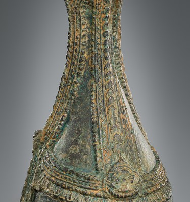 Lot 356 - A BRONZE RITUAL CONCH SHELL WITH A FIGURE OF HEVAJRA WITH YOGINIS, ANGKOR PERIOD, BAYON STYLE